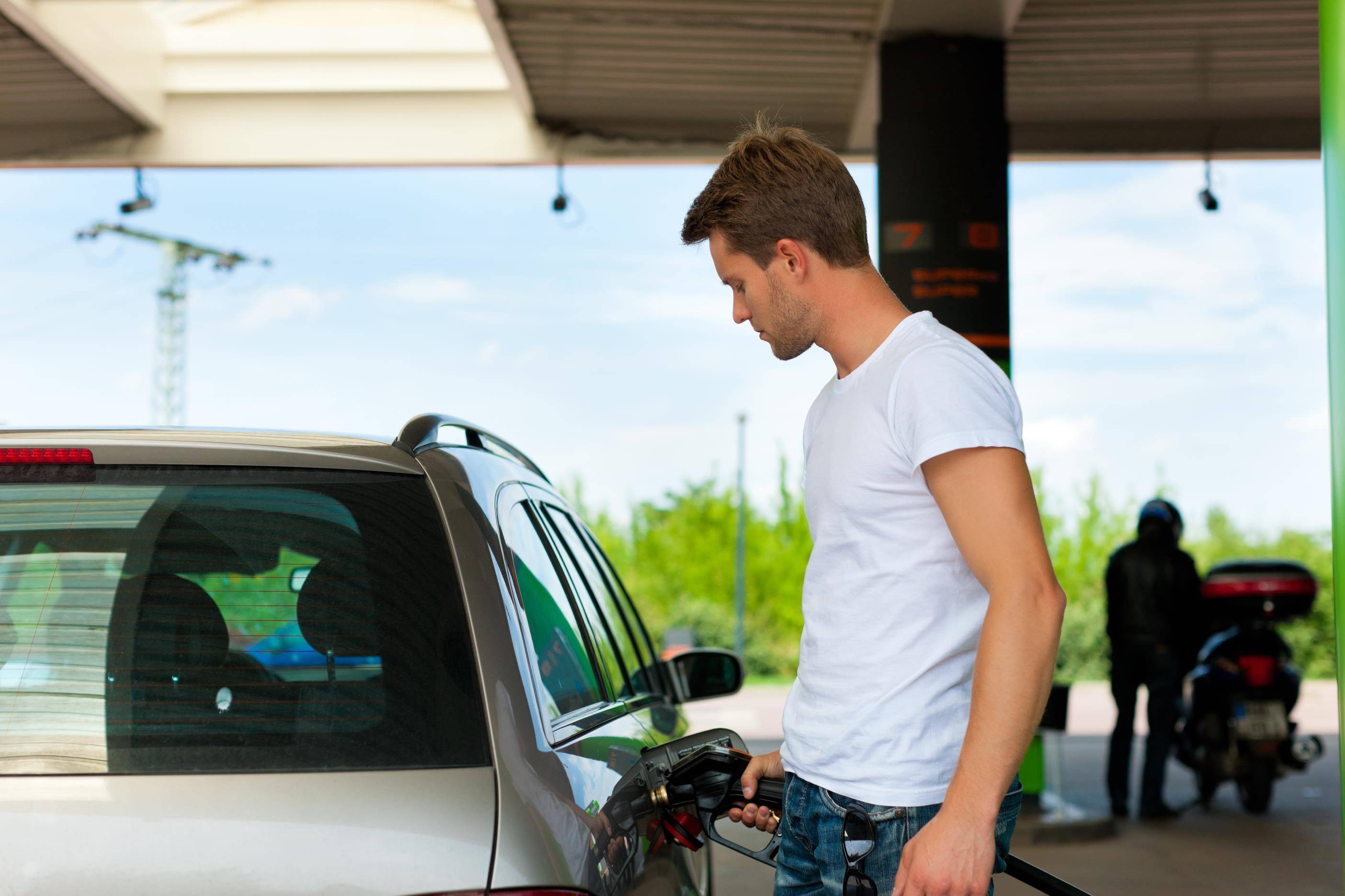 image of a person filling up their car with petrol