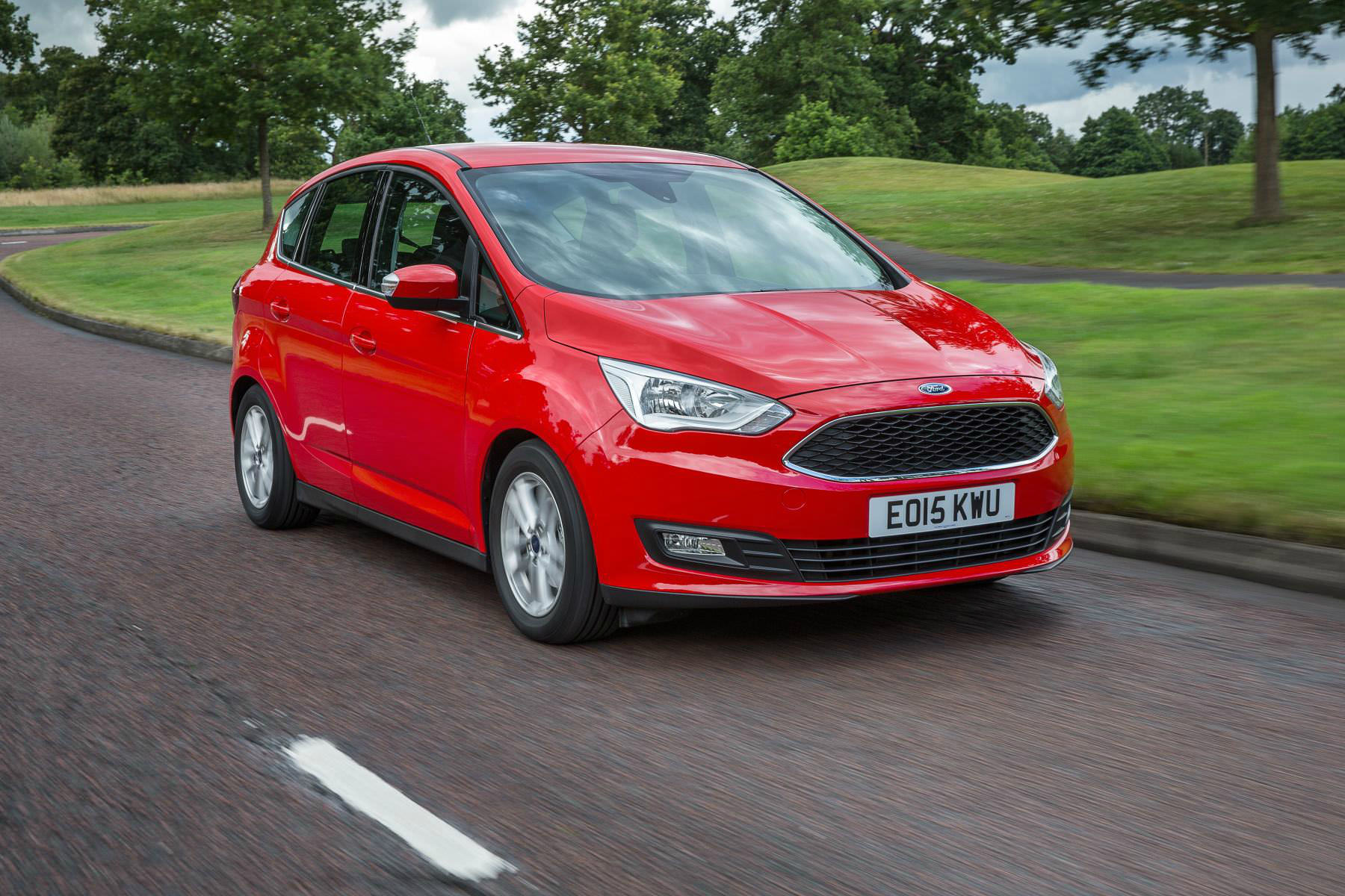 image of a red ford c max car on a city road