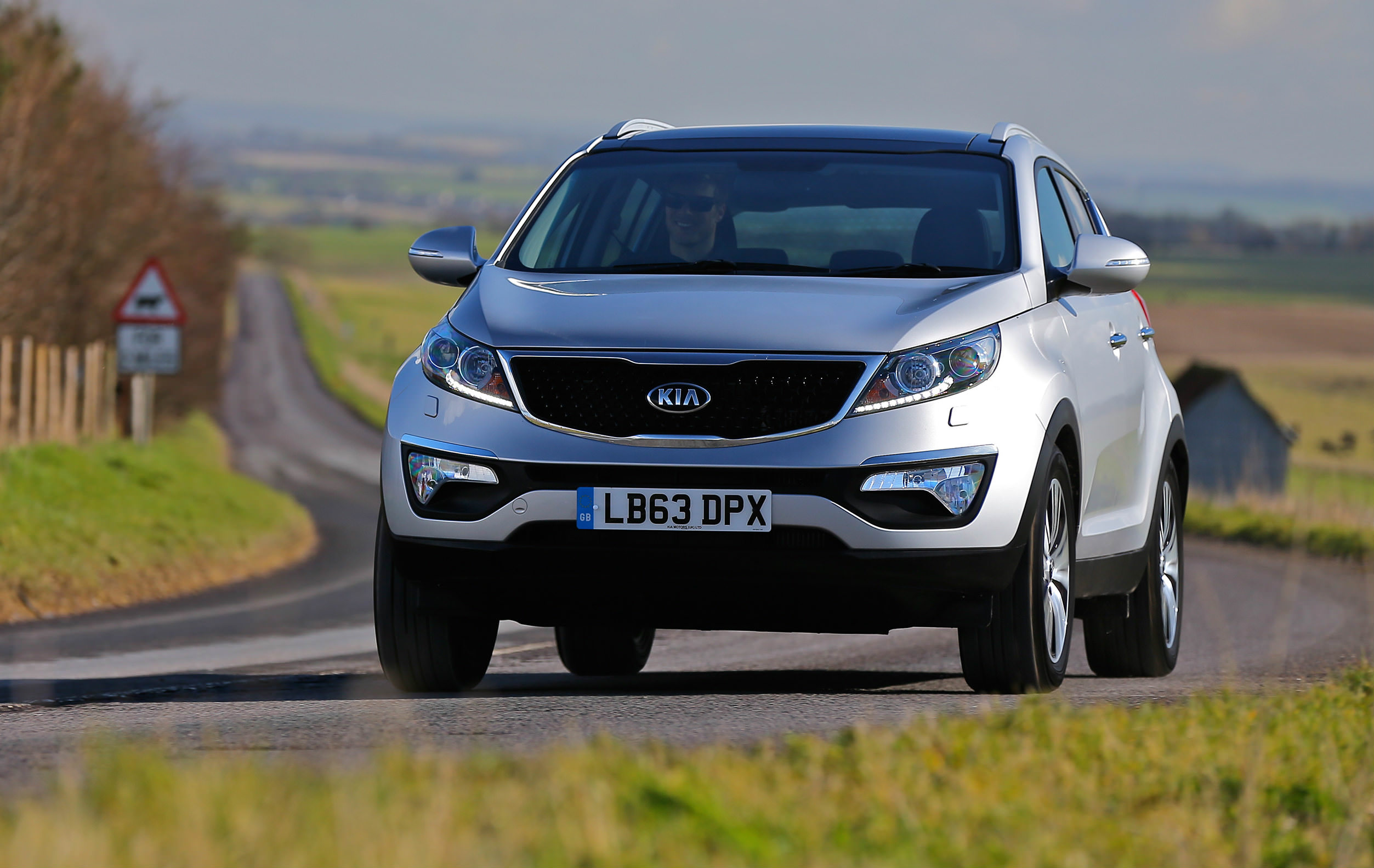 image of a silver kia sportage car exterior