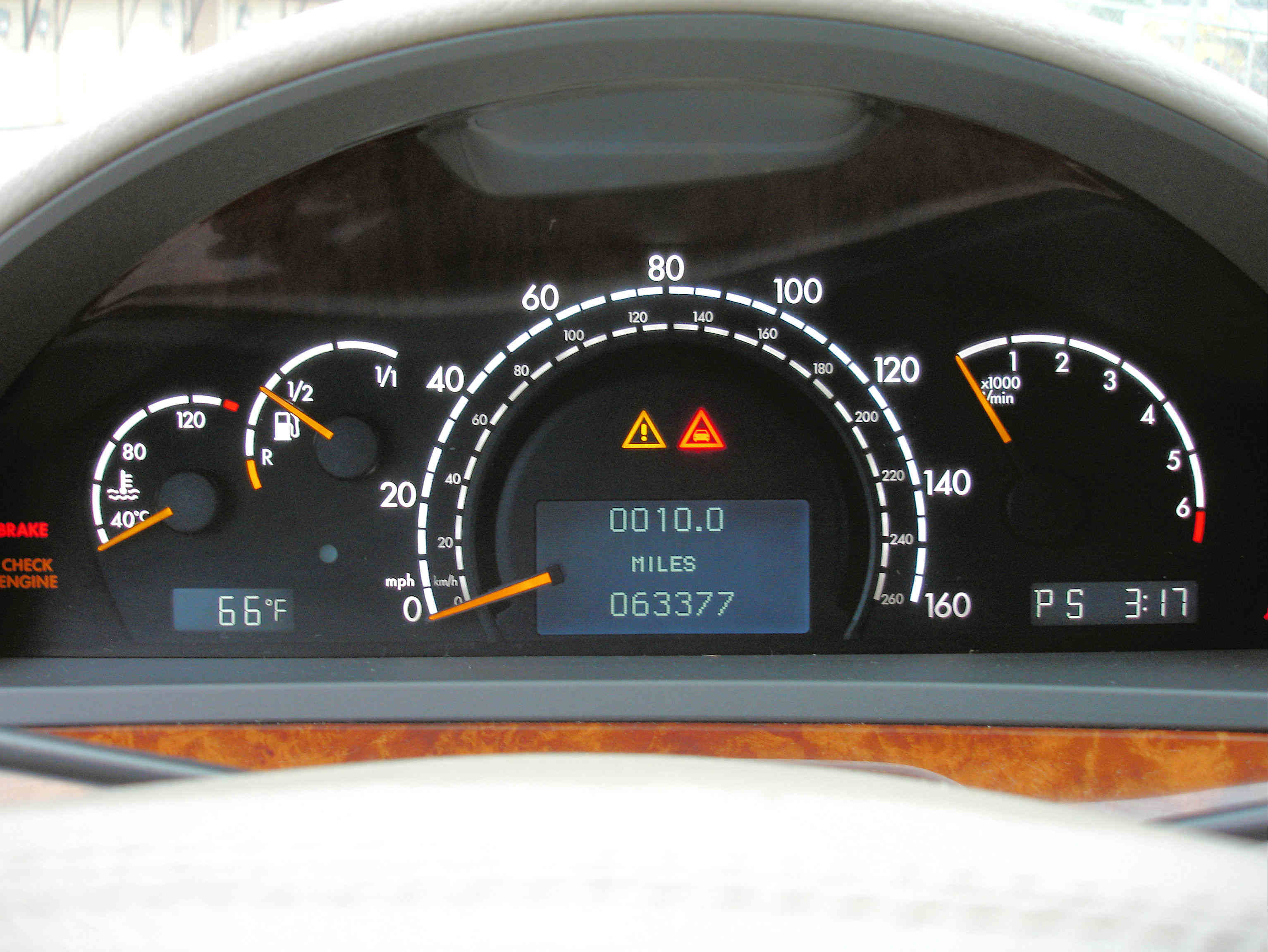 image of mileage and odometer on a car dashboard