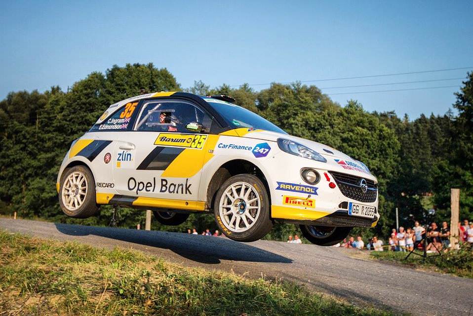 image of chris ingram rally car in mid air over a hill