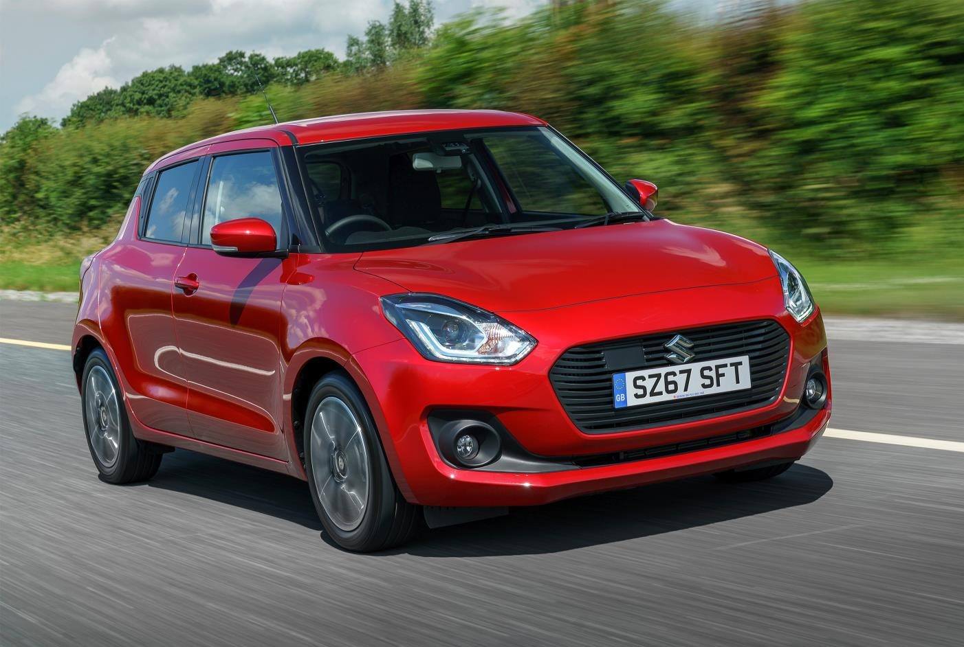 image of a red suzuki swift hybrid car exterior