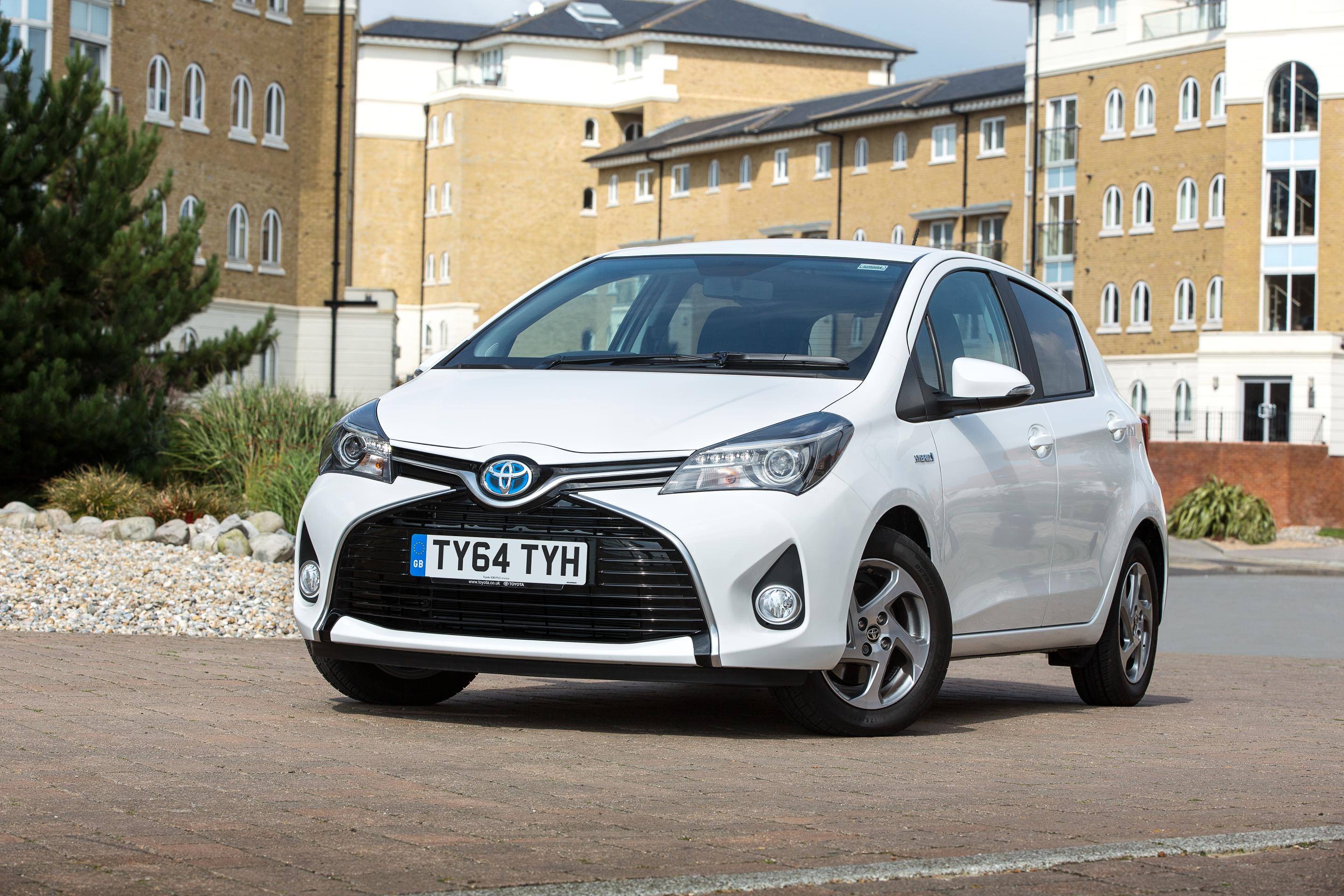 image of a white toyota yaris hybrid car exterior