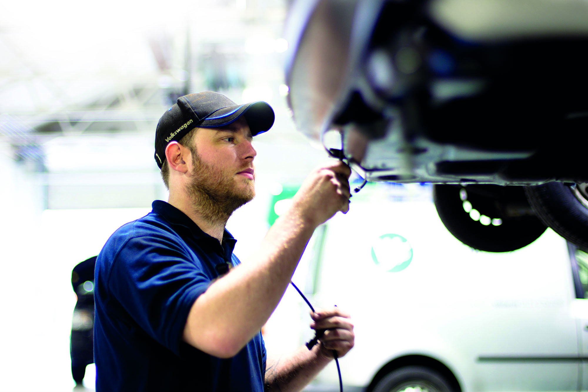 image of a mechanic working on a car as part of an mot test