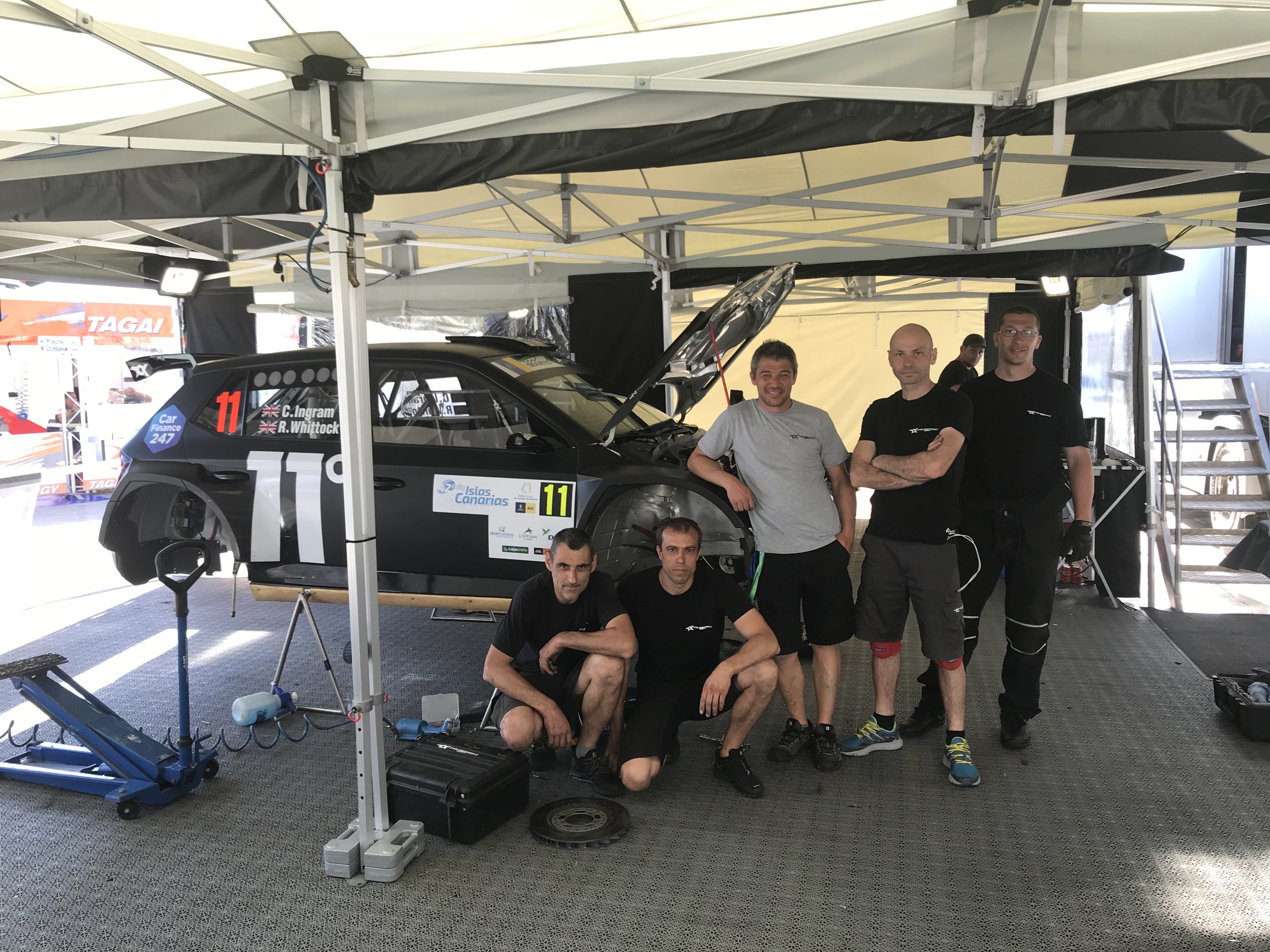 Toksport world racing team in front of Chris Ingram's Skoda Fabia R5