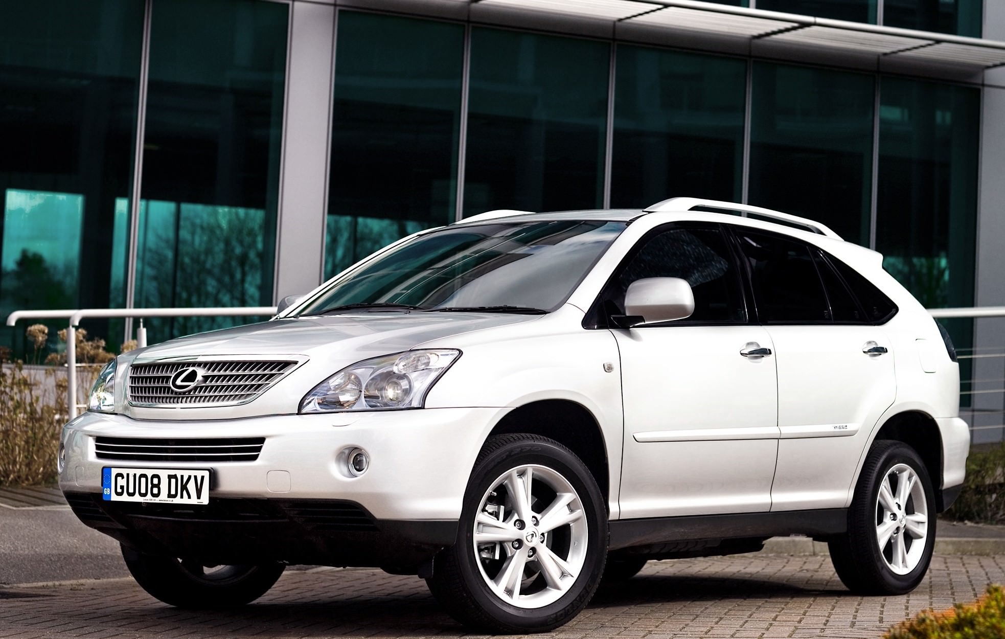 Silver Hybrid SUV Lexus RX 400H parked outside a building