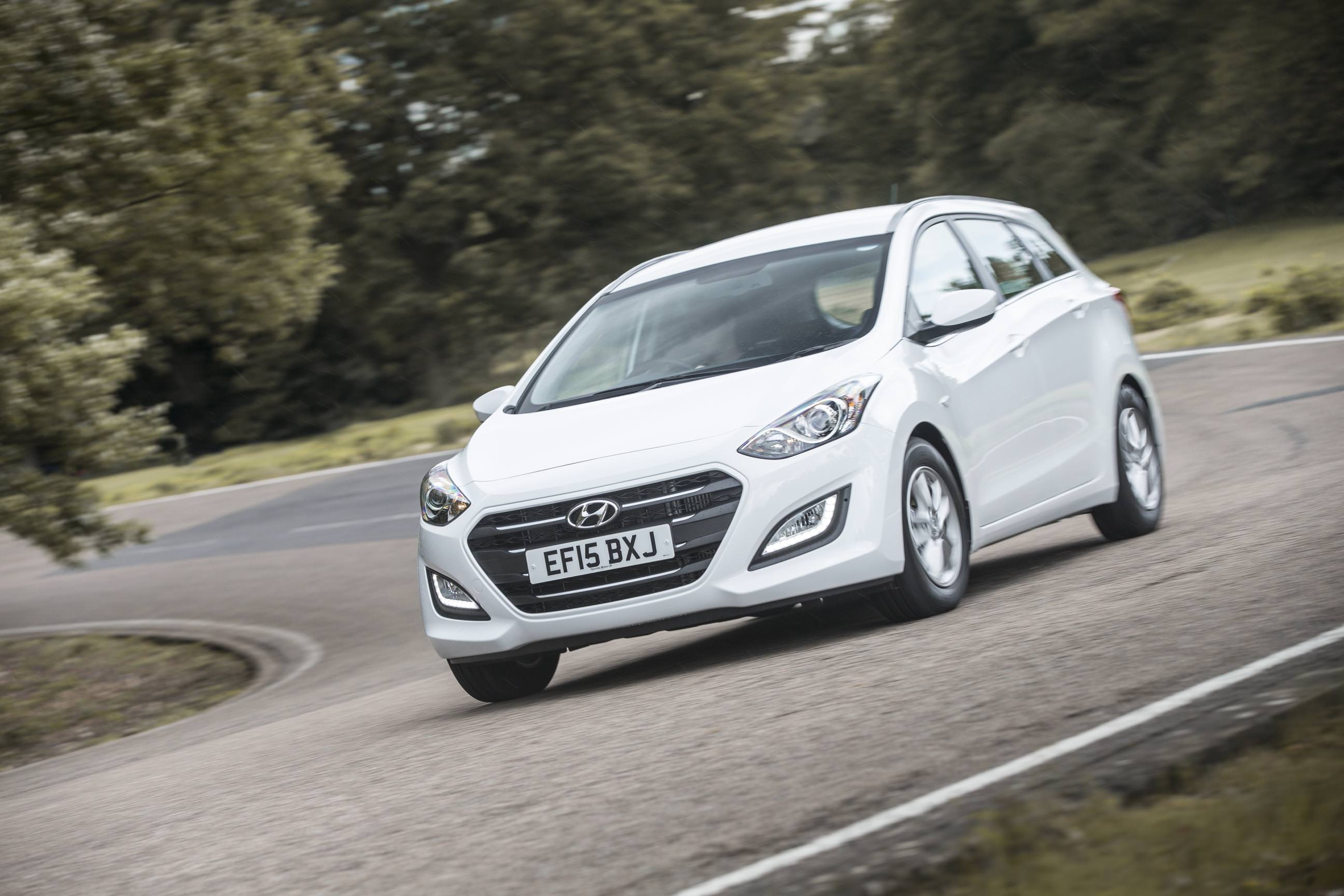 Used Hyundai Car driving around a corner on a road