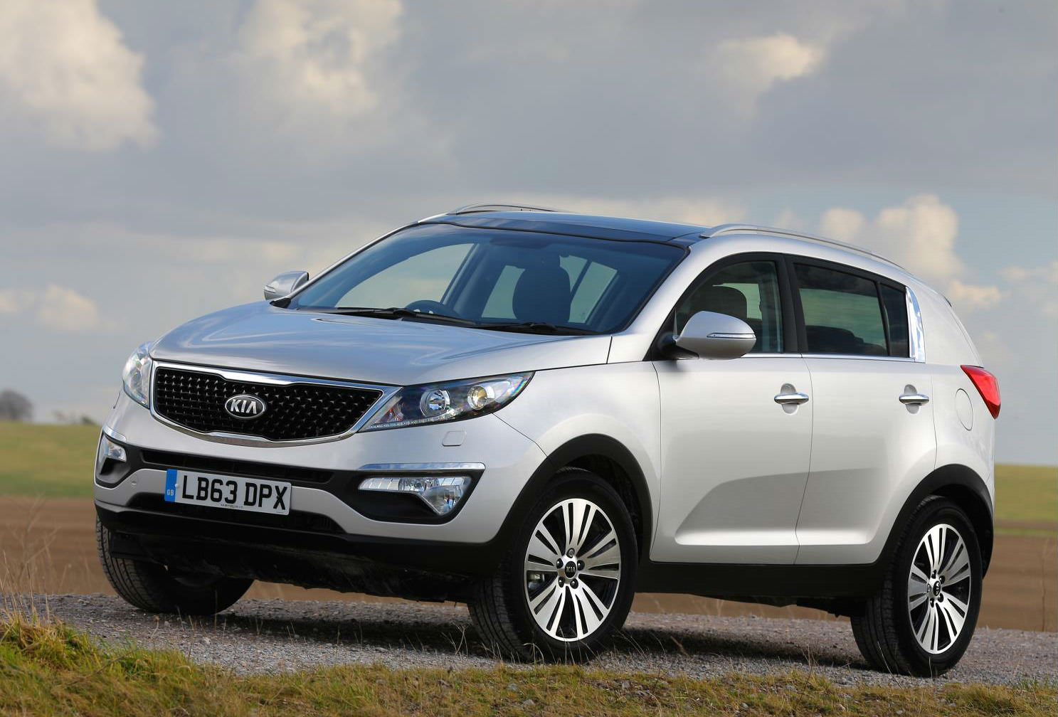 Silver Used Kia parked within a field