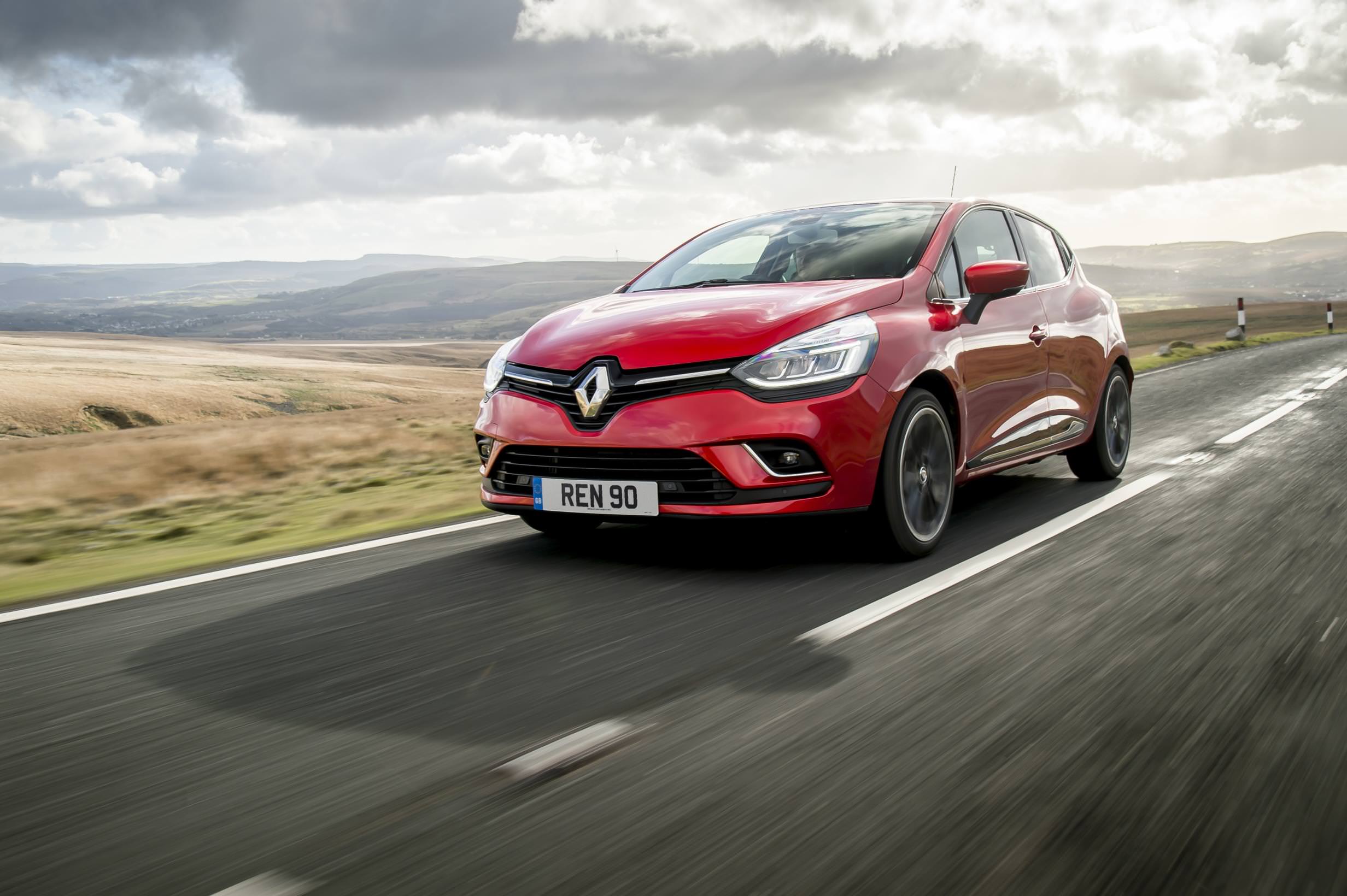 Used Red Renault driving on countryside road