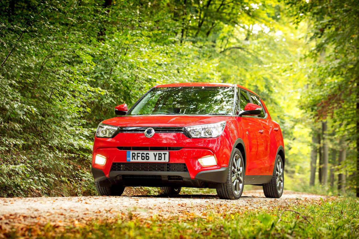 Used Red Ssang driving on a countryside road