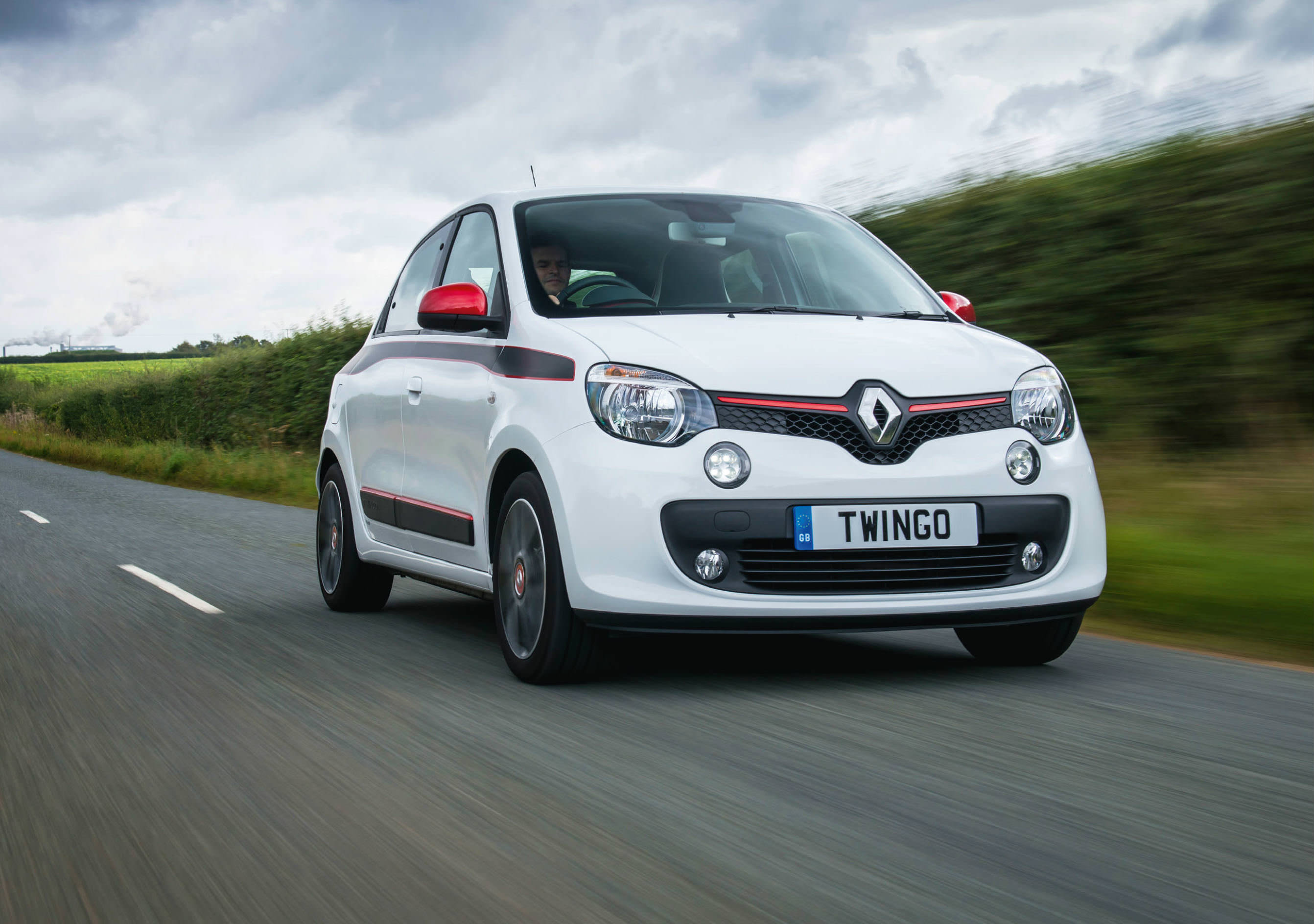 White Renault Twingo driving down countryside road