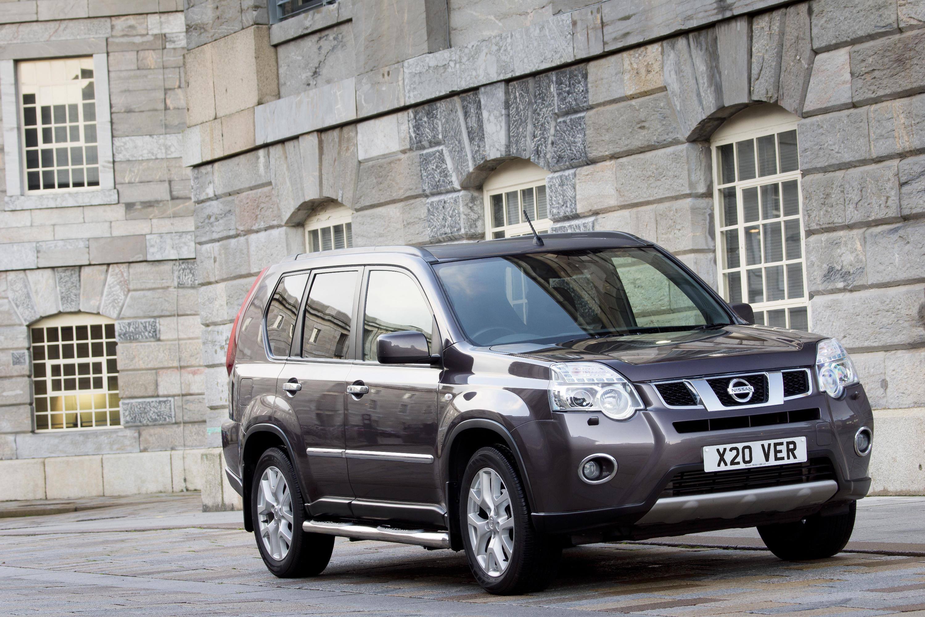 Grey Nissan X-trail parked outside castle 