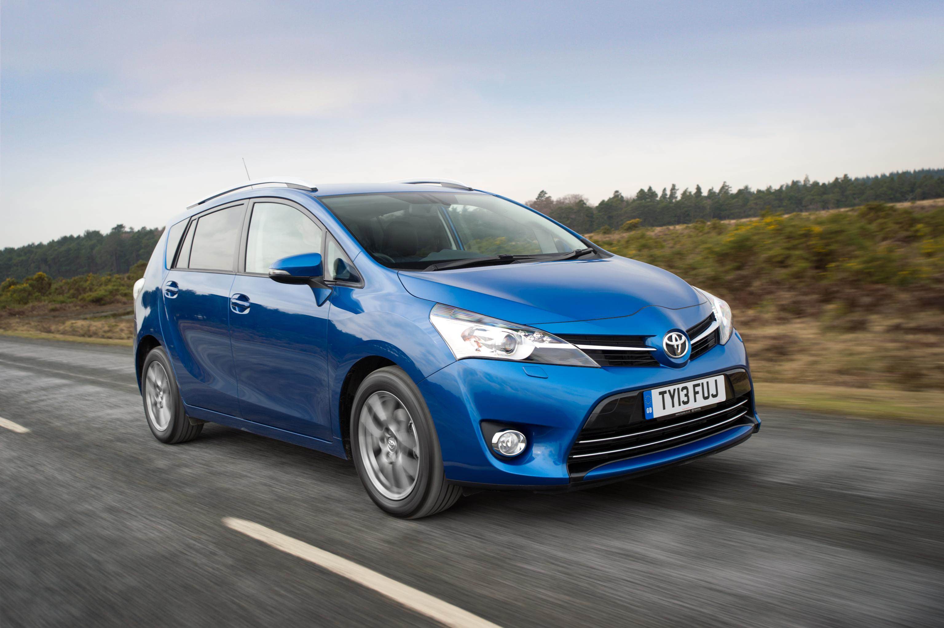 Blue Toyota driving on countryside road 