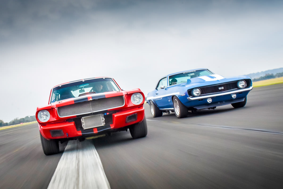 image of two ford mustang cars side by side on a road