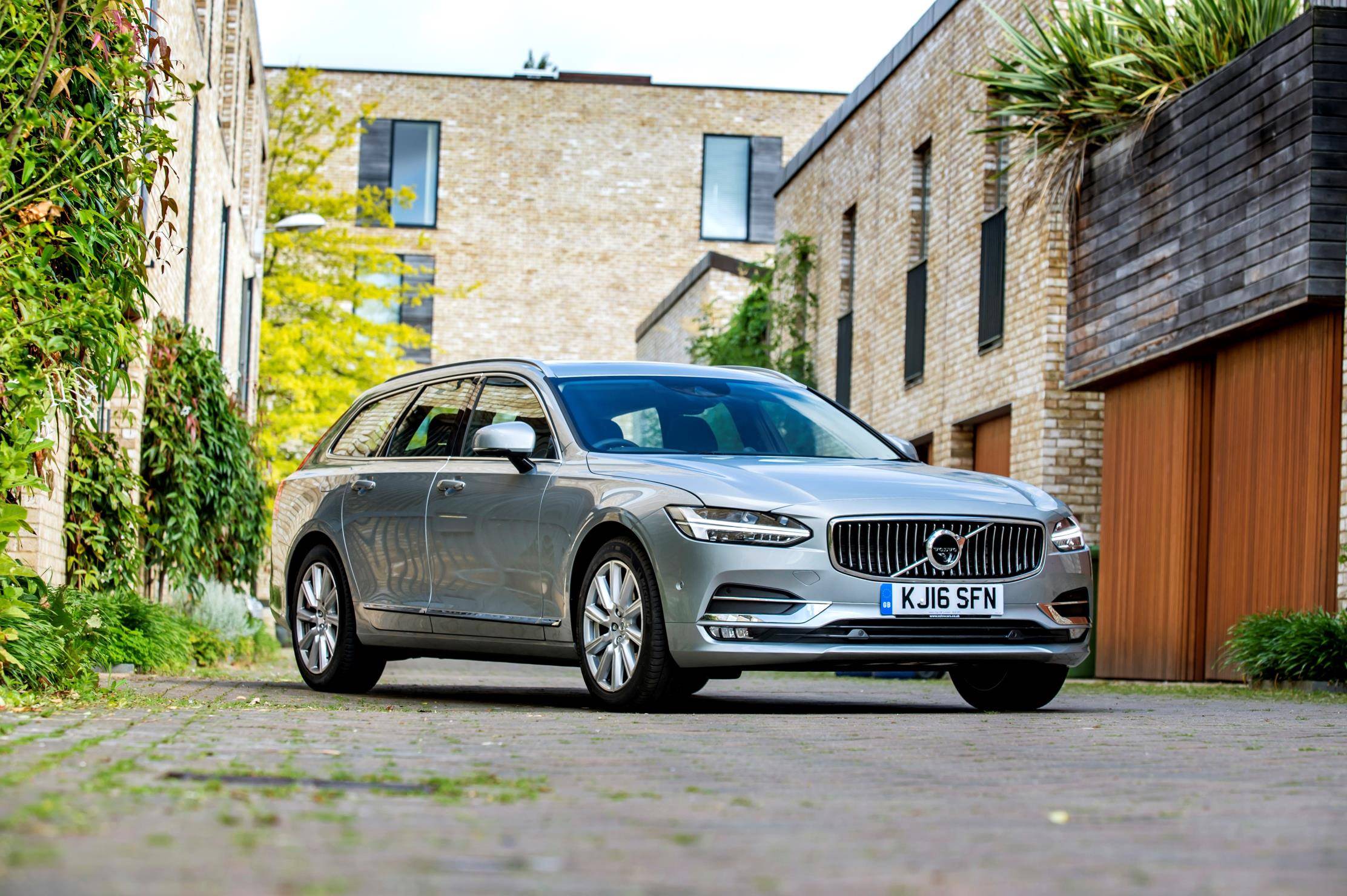 Silver Volvo V90 parked within a city landscape