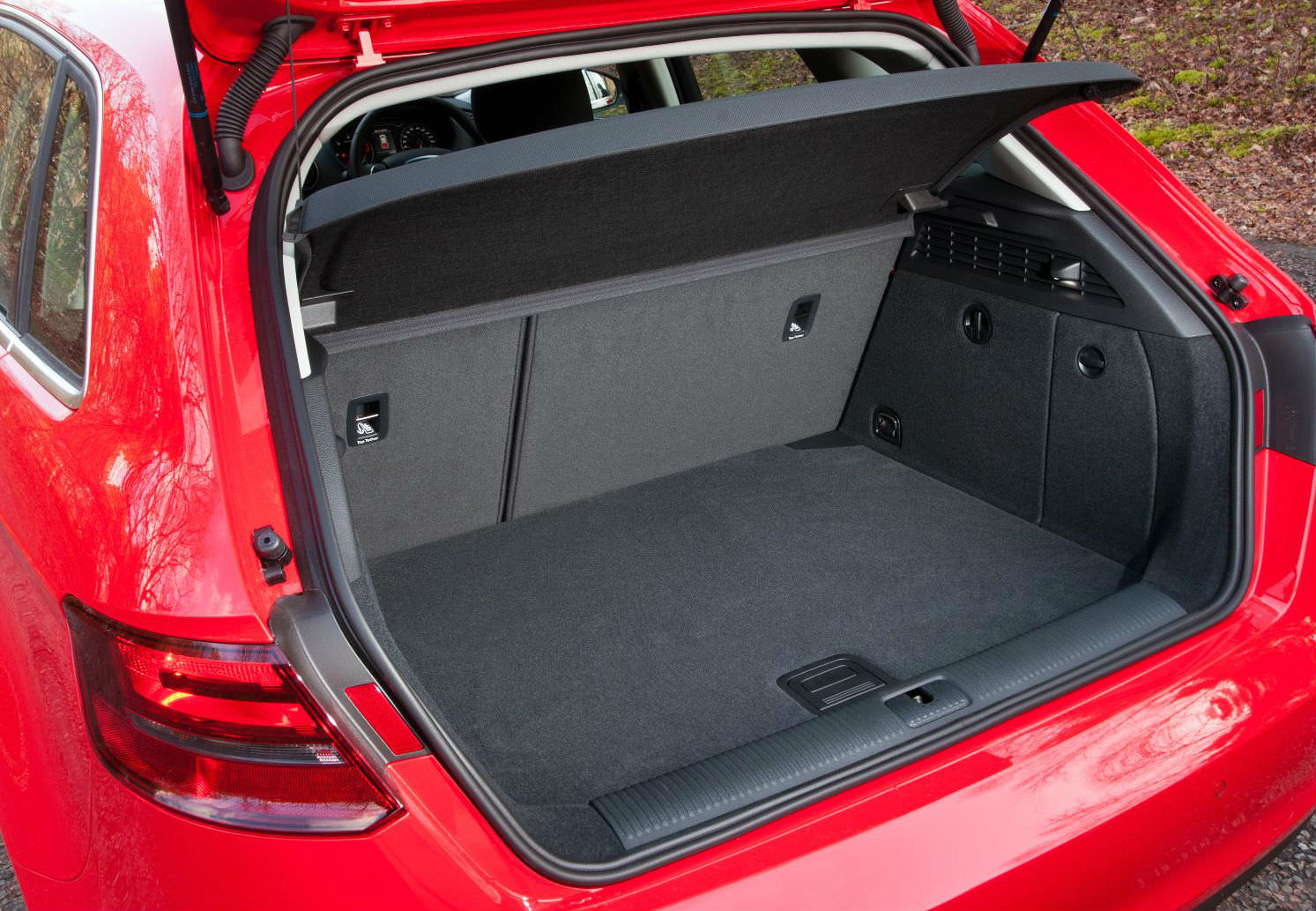 image of a red audi a3 sportback car exterior with boot open