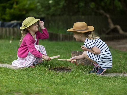 Two children learning through play outside at our private primary school