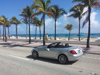 convertible car along a miami beach road