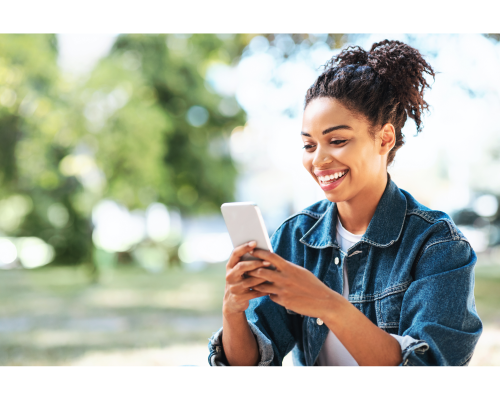 girl looking at her mobile phone outdoors