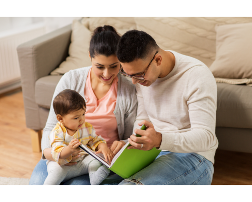 young couple reading to a baby