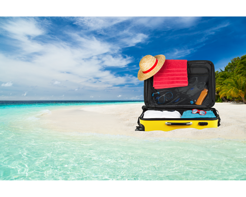 open suitcase on wide sandy beach