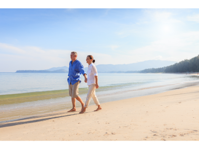 couple walking along a beach holding hands