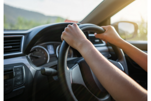 person steering a car