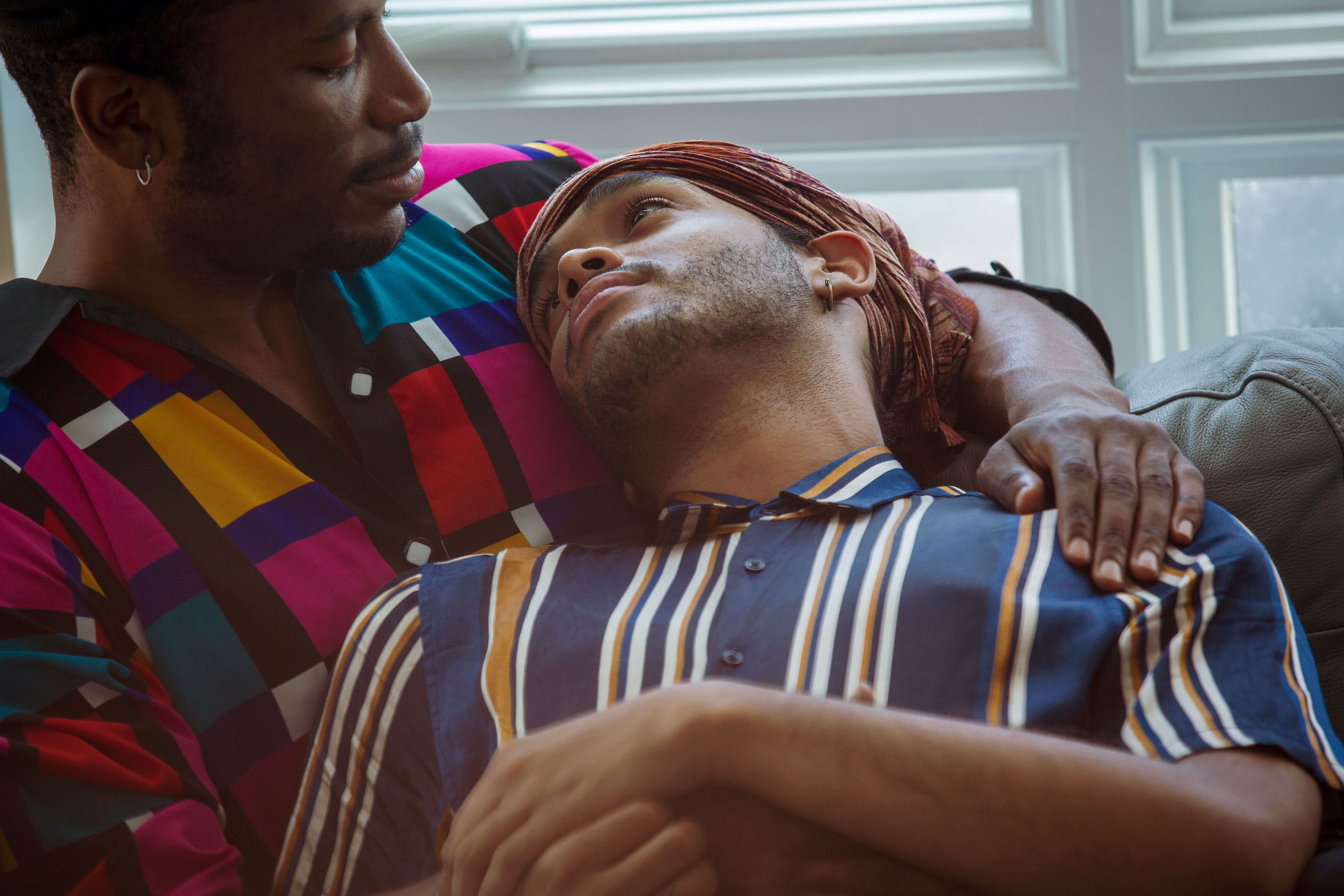 A couple shares an embrace as they look at each other.