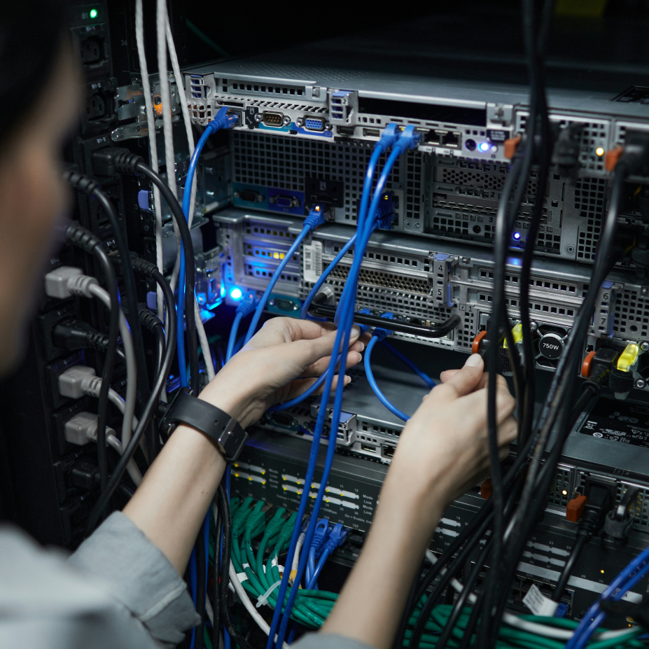 Someone is touching cables on an electrical unit.