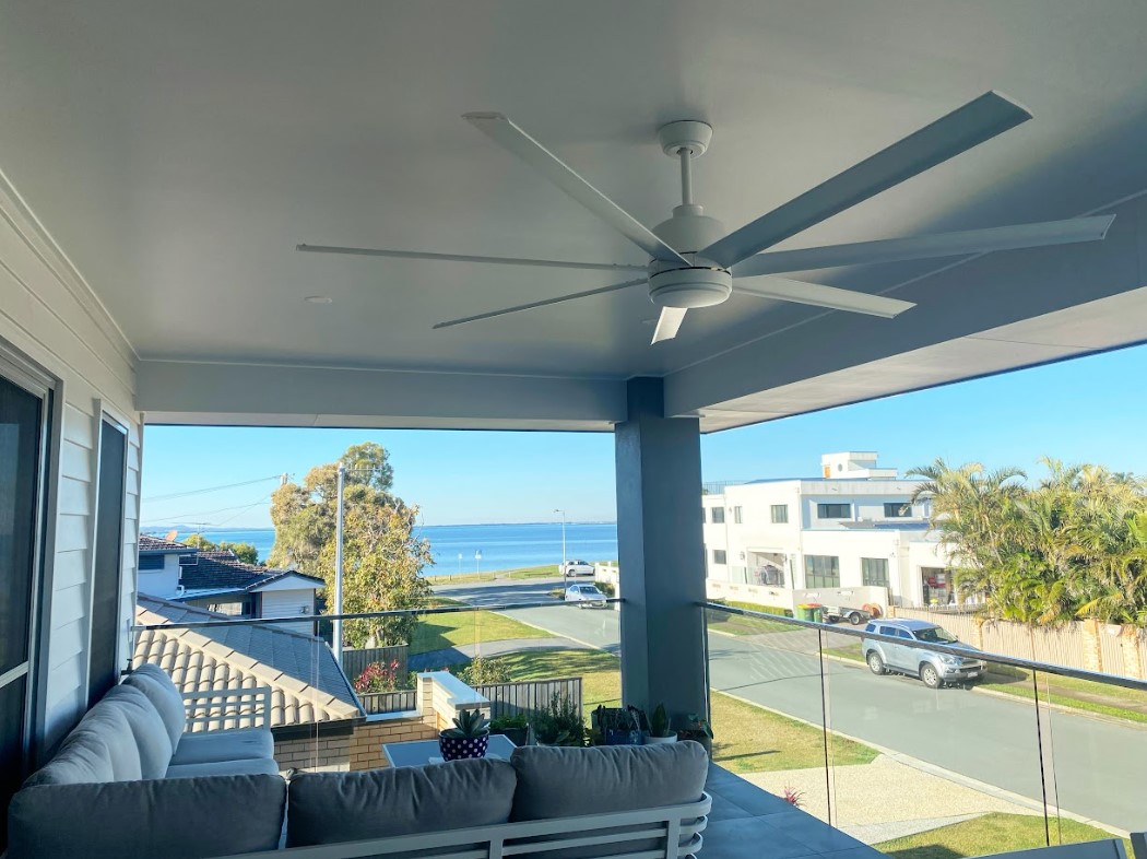 Modern outdoor ceiling fan installed on a Brisbane coastal with ocean views, providing comfort and airflow for residential living.