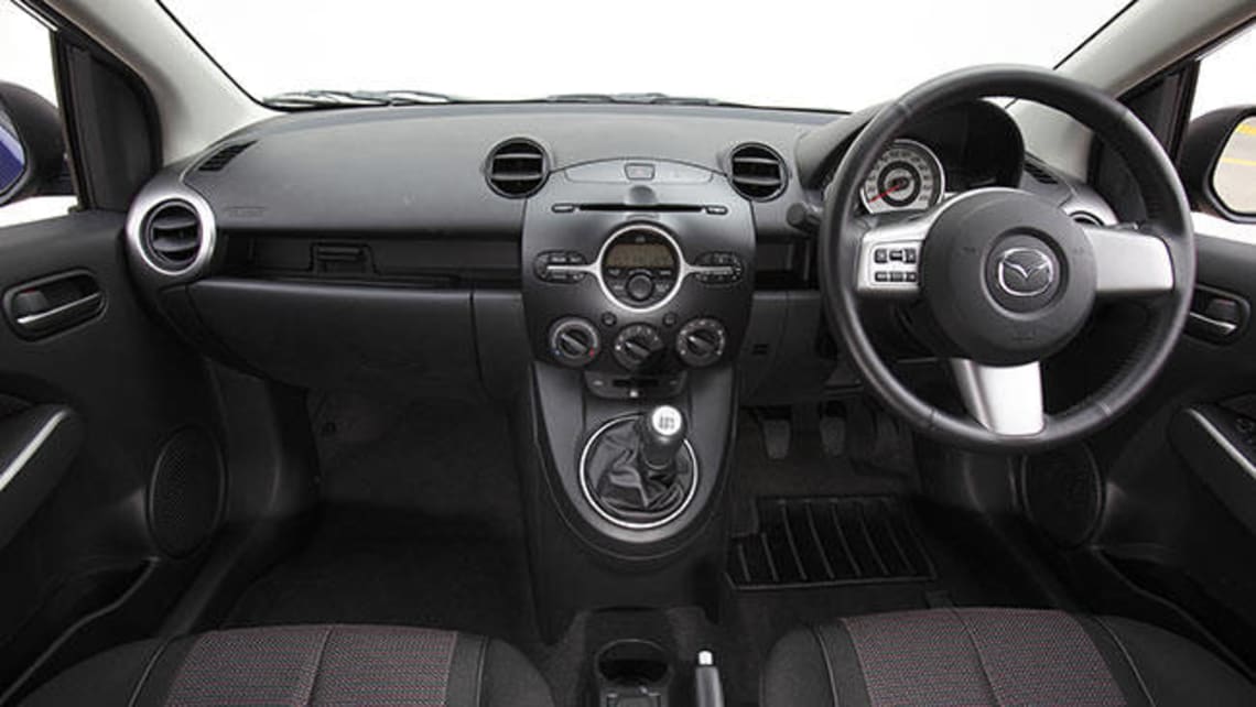 https://res.cloudinary.com/carsguide/image/upload/f_auto,fl_lossy,q_auto,t_cg_hero_large/v1/editorial/mazda2-genki-hatch-inside-2010.jpg