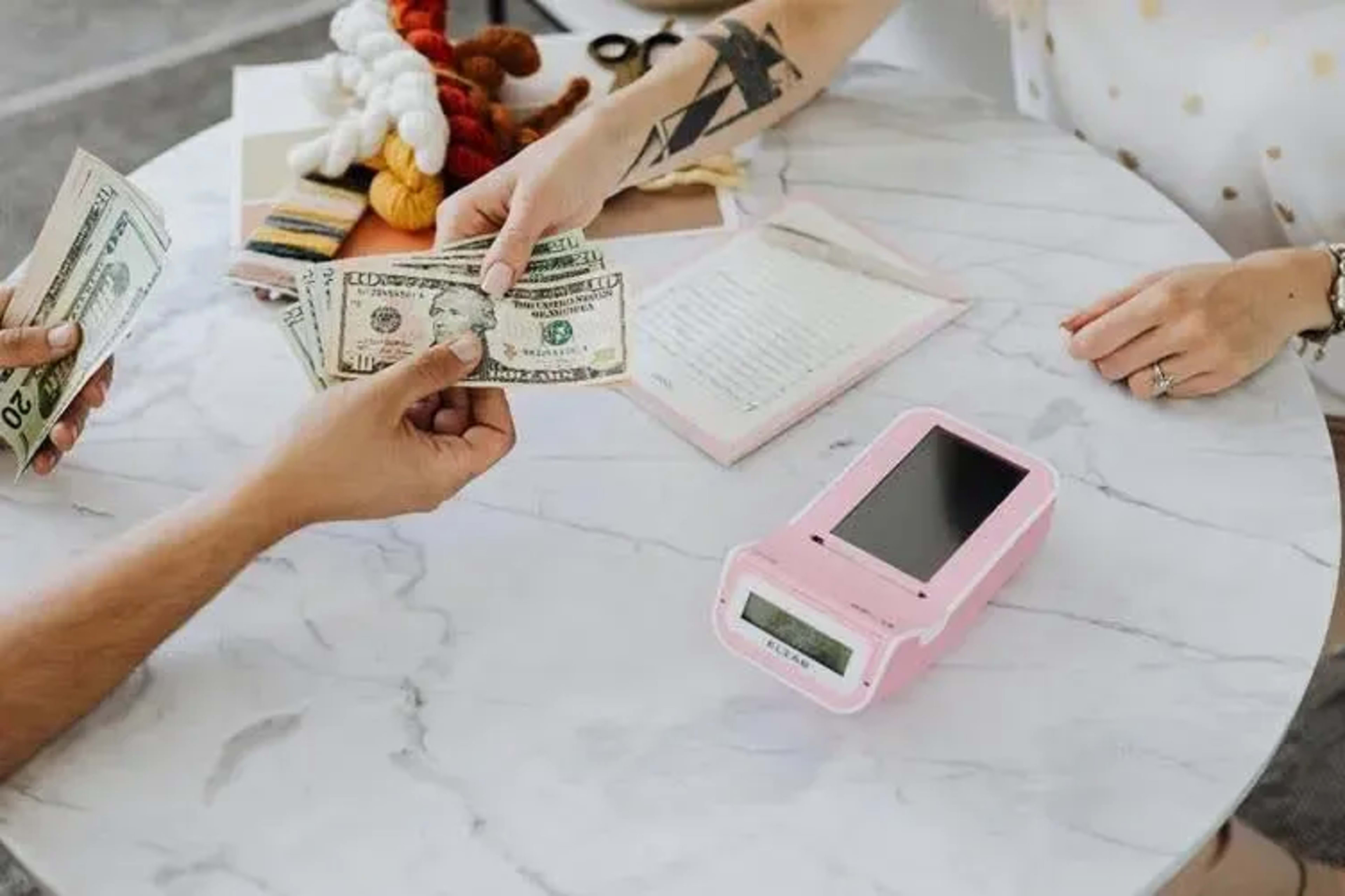 hands-holding-us-dollar-bills.webp