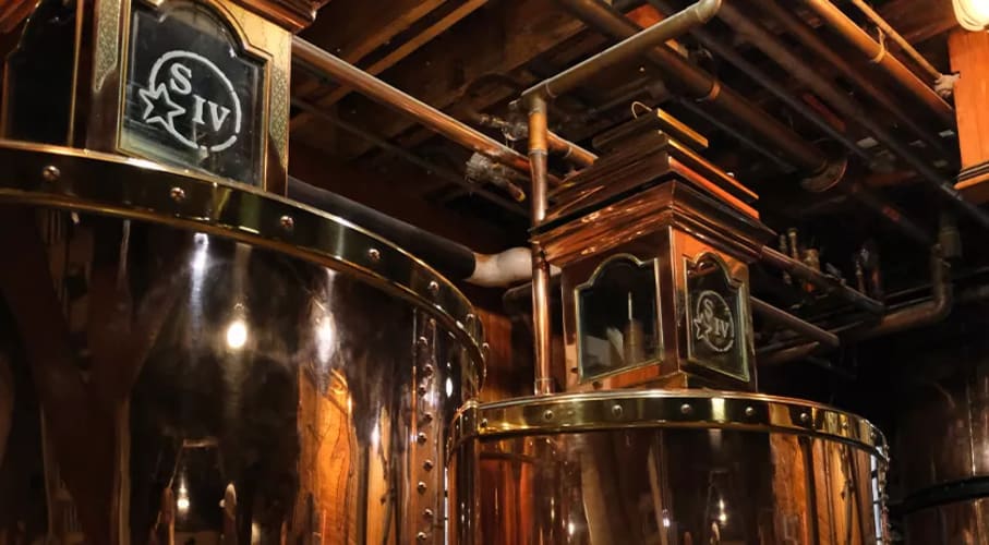 Two Maker's Mark distillation stills with the Maker's Mark family logo embossed.