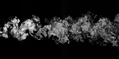 Entrainment into a turbulent wake from a turbulent background and the turbulent/turbulent interface