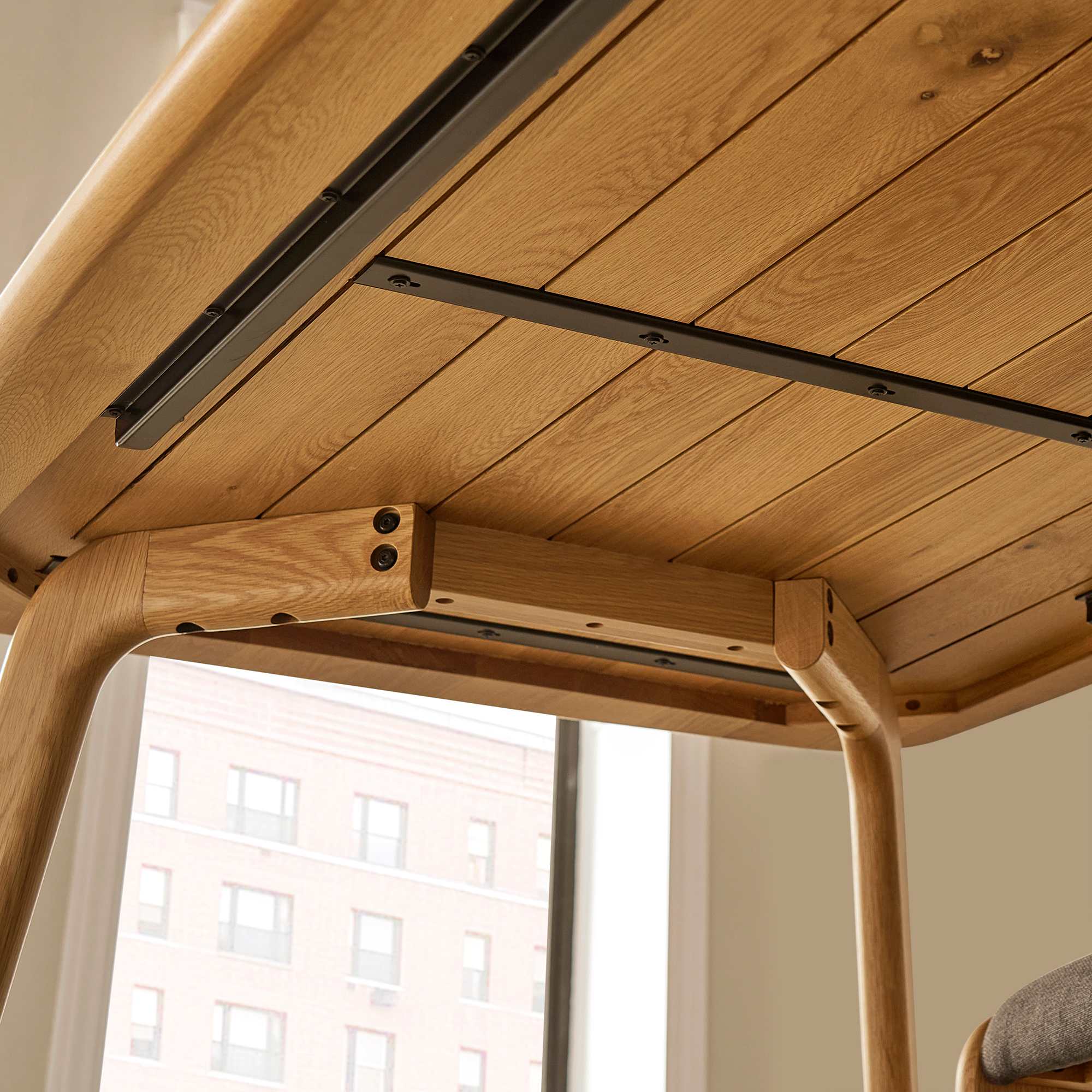 Close-up detail of the wooden table frame and joinery of the Vincent dining set.