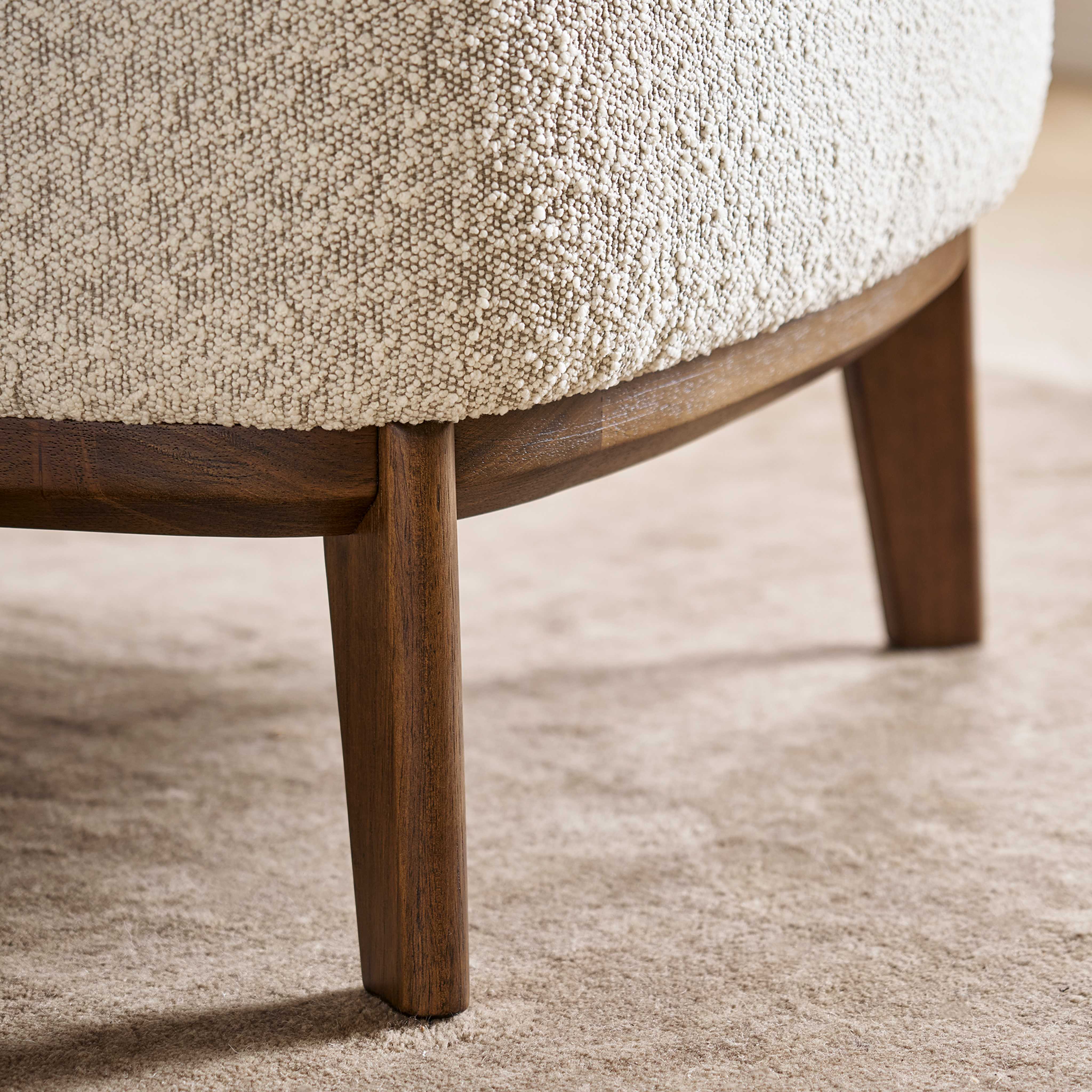 Close-up of the textured bouclé fabric on an armchair.