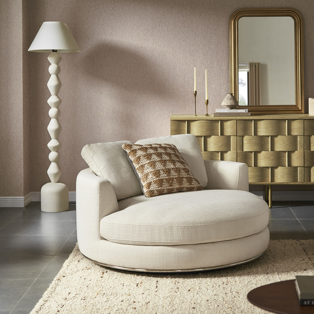 A 1.5-seater swivel armchair with a brown patterned pillow.