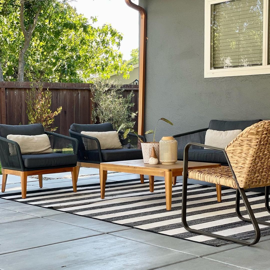 Two outdoor lounge chairs, an outdoor sofa, and a rattan chair placed on the deck.