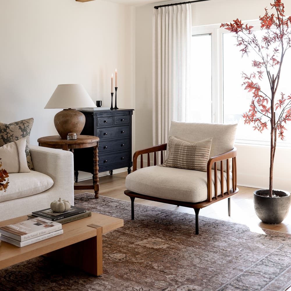 An armchair with a wooden spindle frame design in a living room.