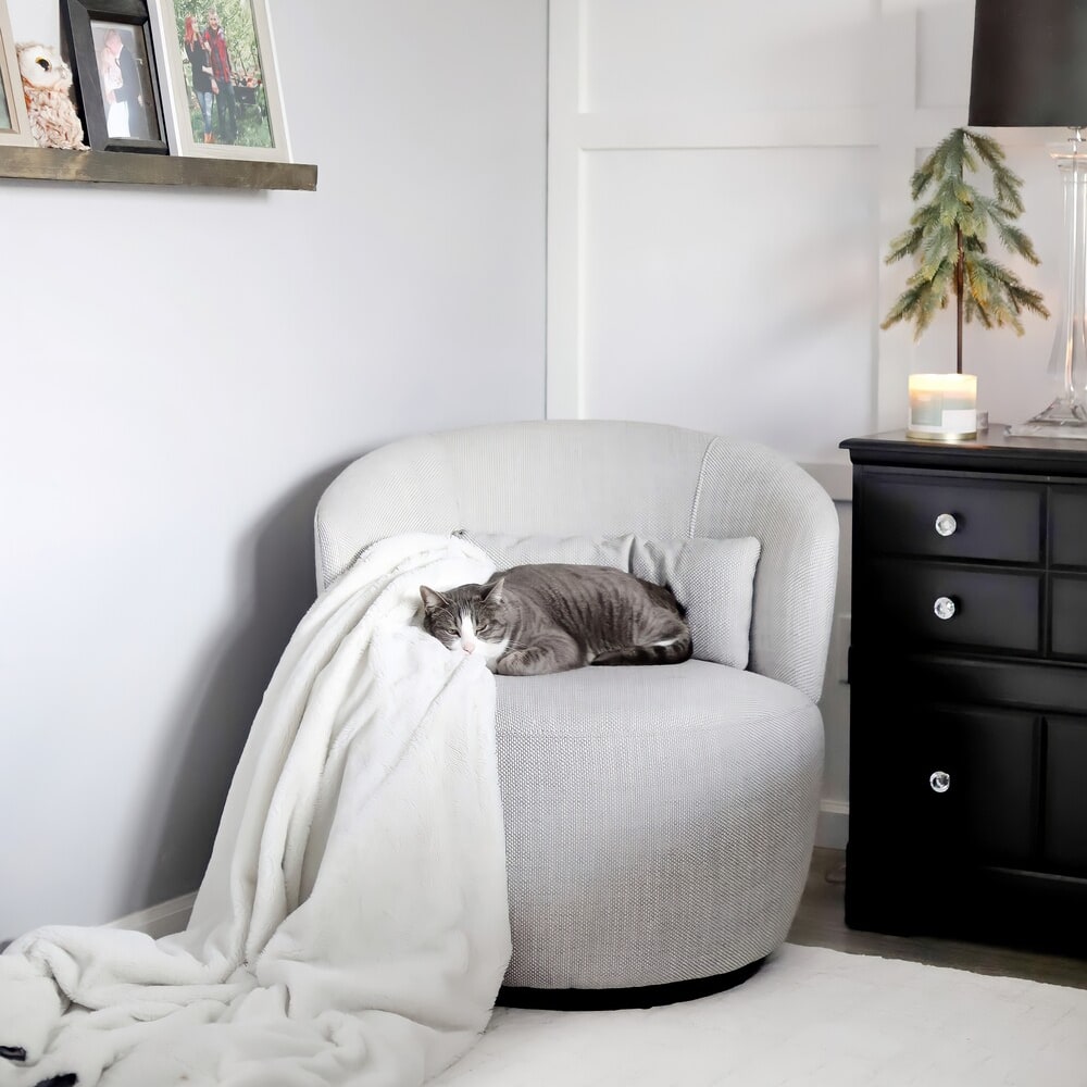 A cat sleeping on a swivel armchair.