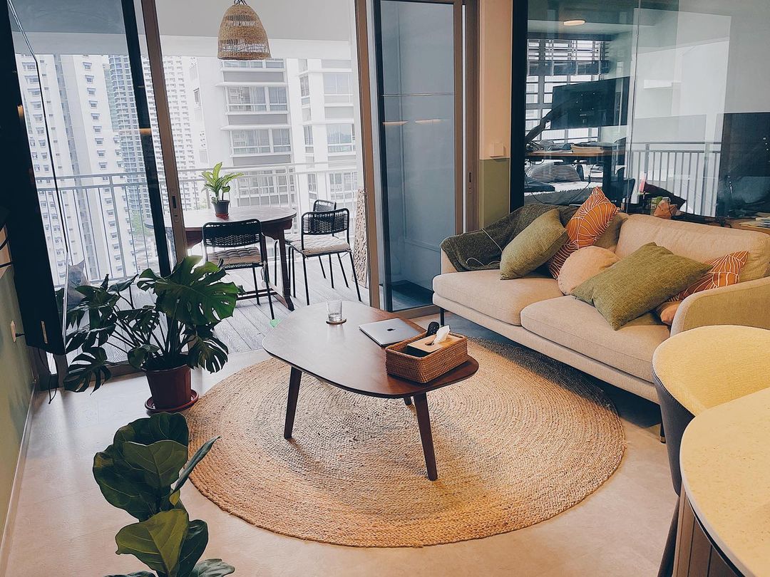 A living room with a coffee table, jute rug, and grey sofa.