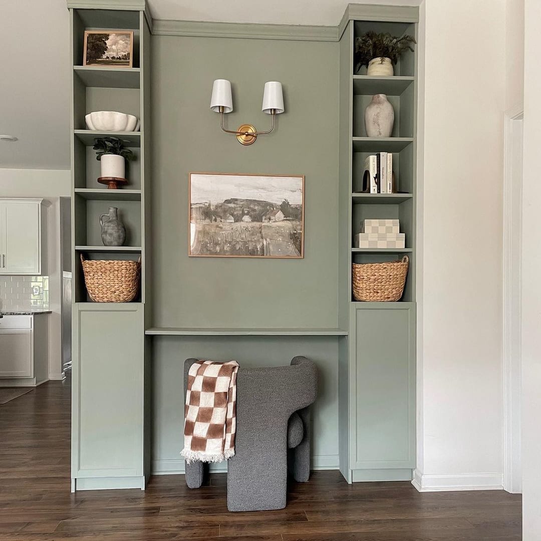 A grey armchair with a checkered throw placed at an accent wall painted in a mint green colour.