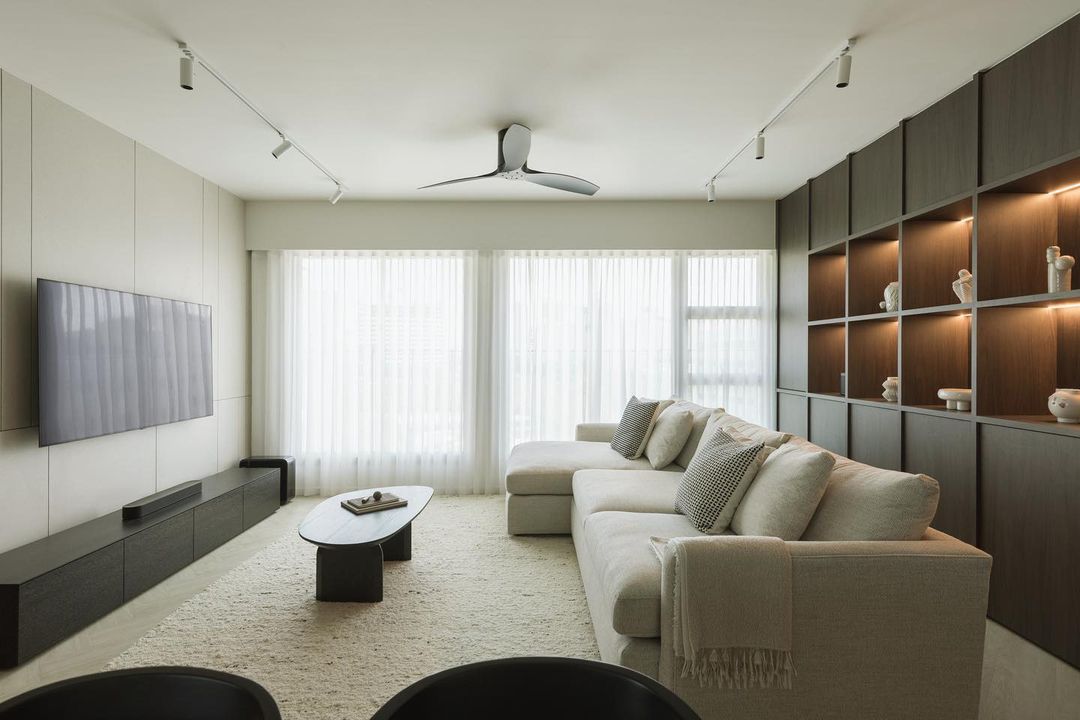 A sectional sofa with a built-in wall shelf behind it in a living room.