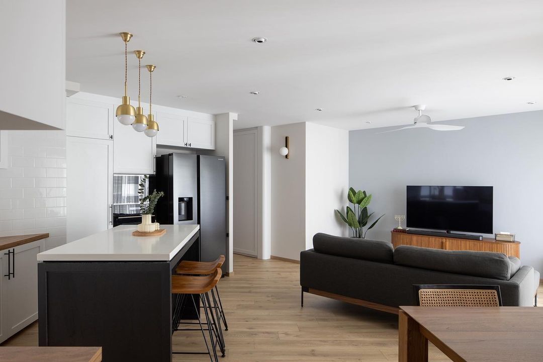 An open layout home with a kitchen island, living area, and dining space.