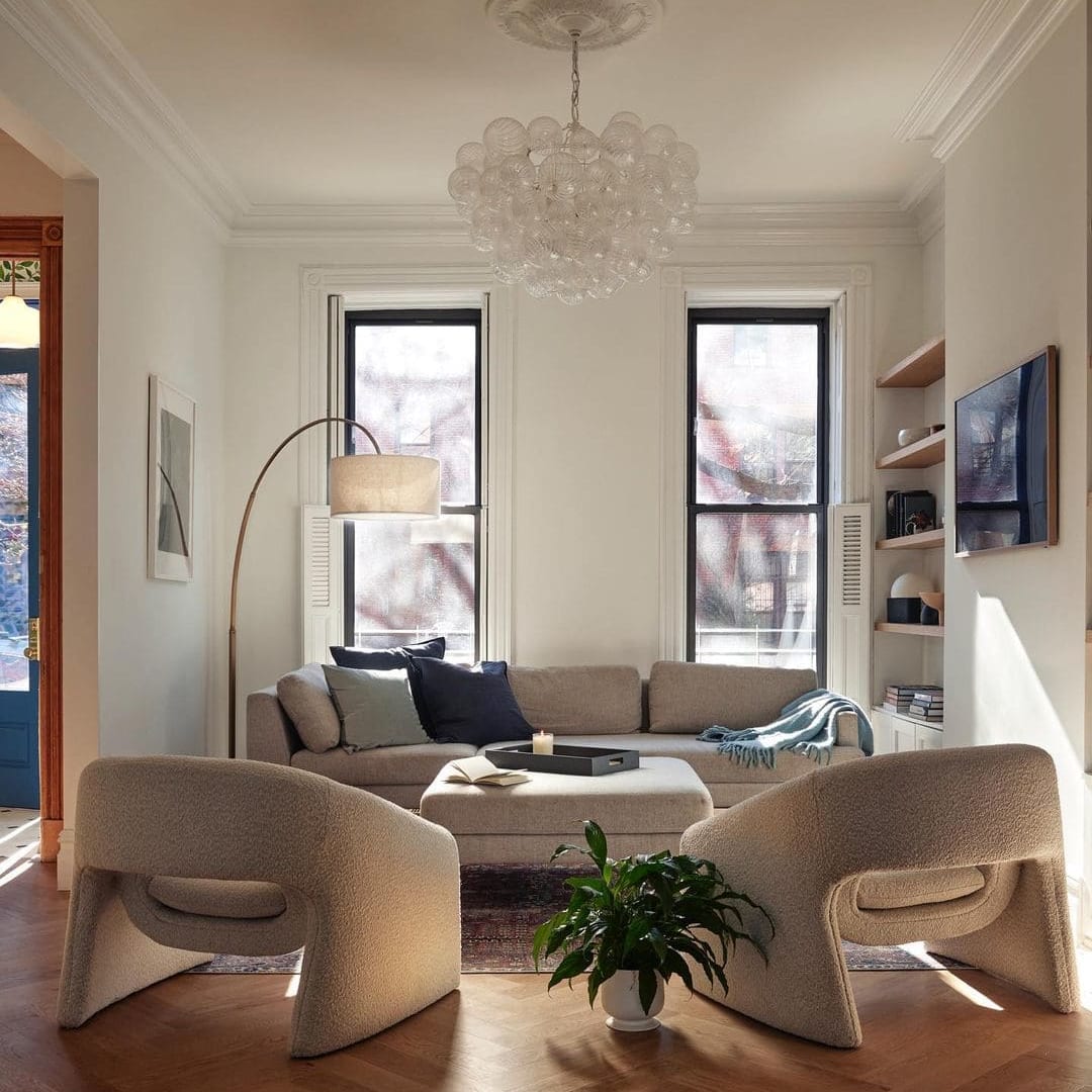 Two armchairs placed directly opposite a sofa in a living room.