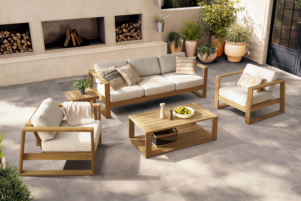A teak outdoor lounge set with a 3-seater sofa, two lounge chairs, and a coffee table.