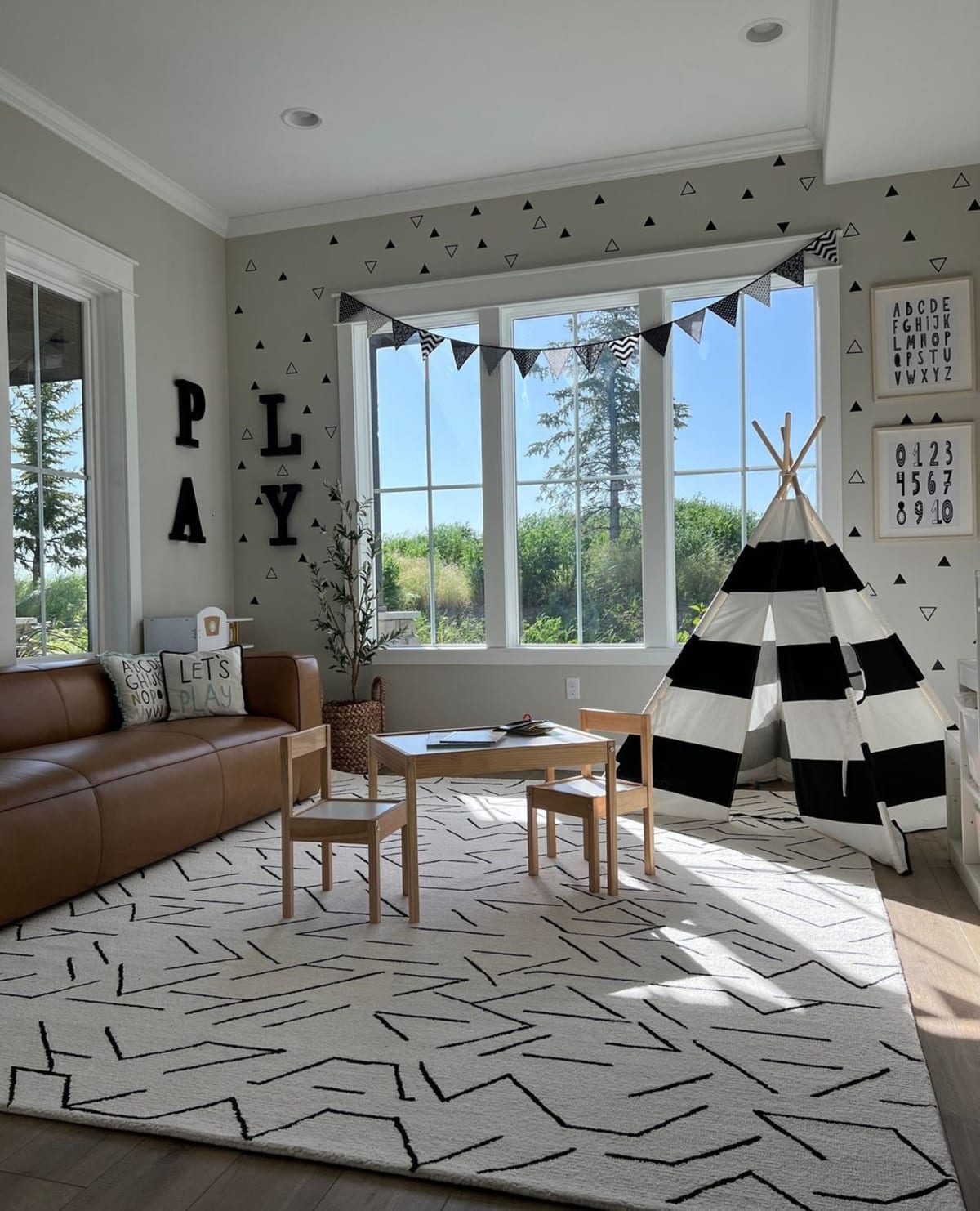 A wool area rug with black patterns.