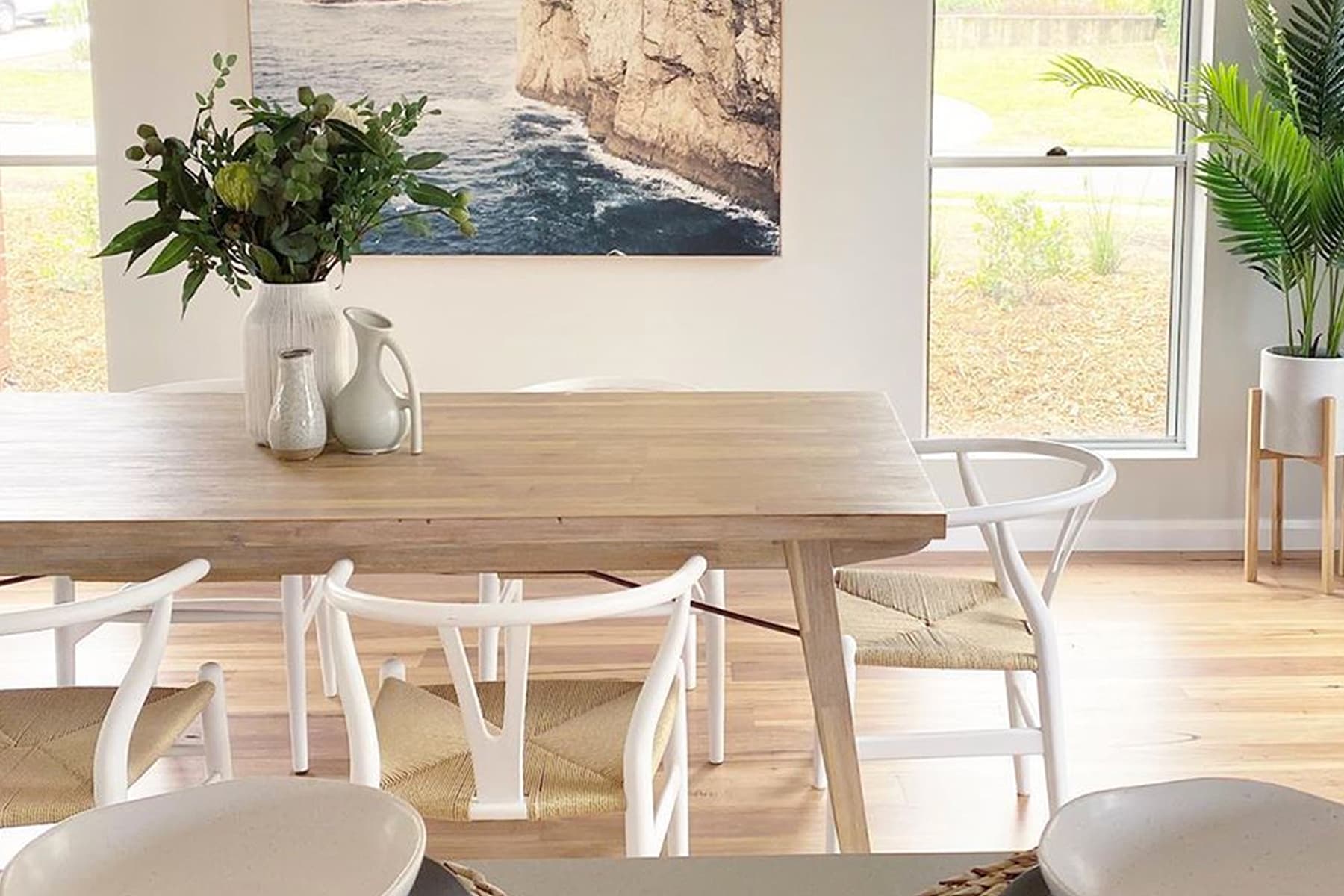 Bright coastal home with dining table and chairs