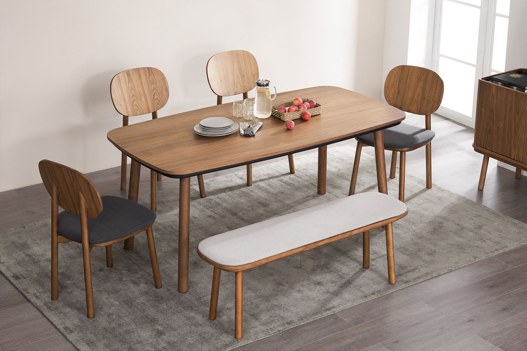 Wooden dining table, chairs and bench in dining room