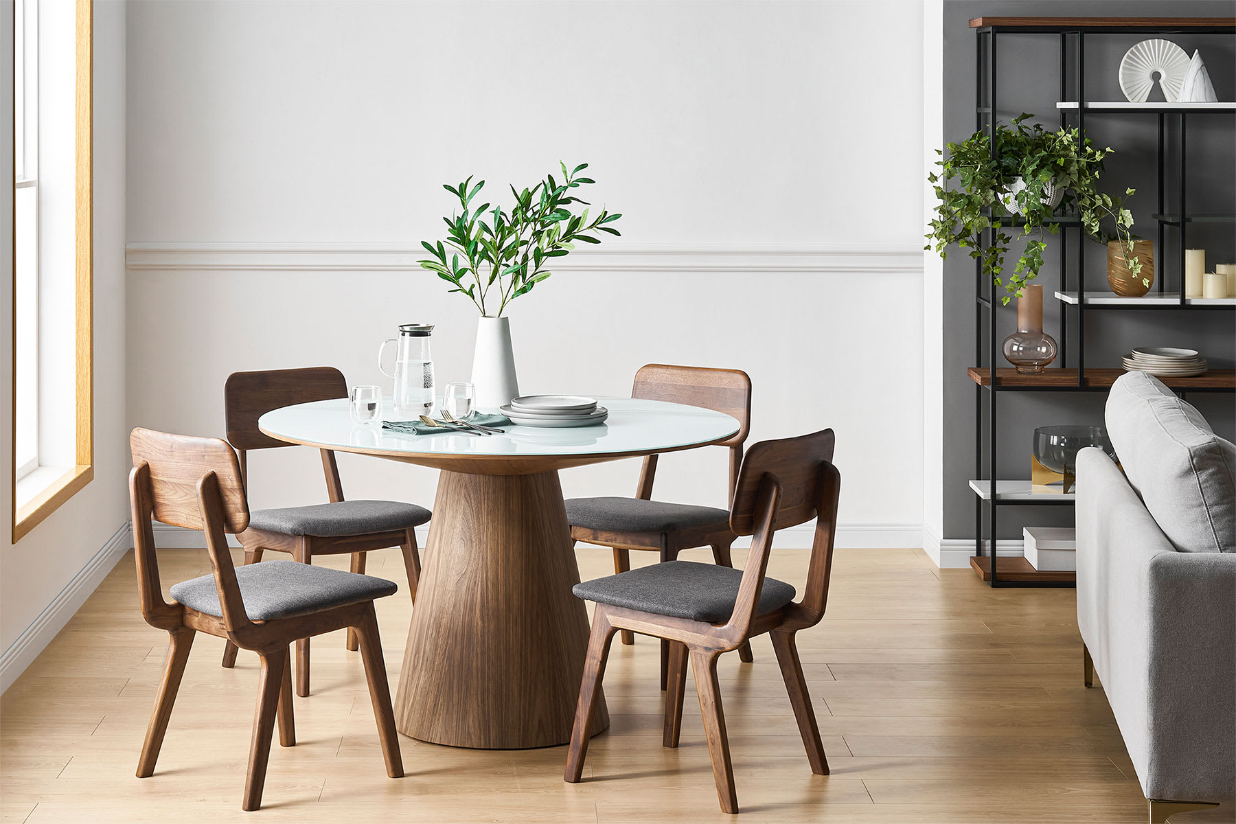 Round dining table, chairs and plant